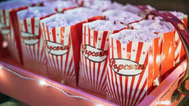 2 rows of popcorn in red and white bags