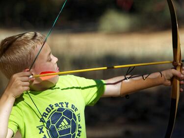 A child pulling back an arrow