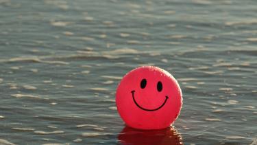 A red beach ball with a smiley face
