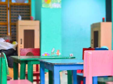 Empty coloured chairs in a classroom