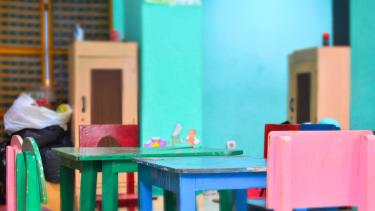 Empty coloured chairs in a classroom