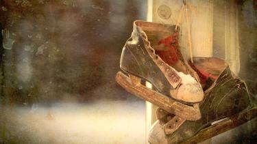 Ice skates hanging on a nail