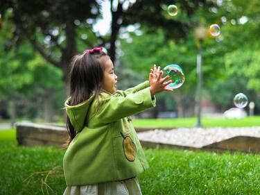 Child reaching for a balloon