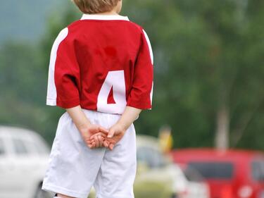 Child wearing red soccer jersey